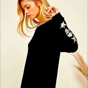 Blumin black top with skull & stars accenting the sleeves.